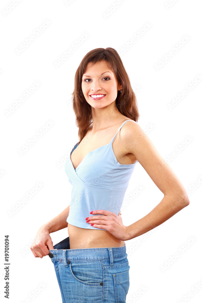 Happy young woman in old jeans pant after losing weight. Stock Photo |  Adobe Stock