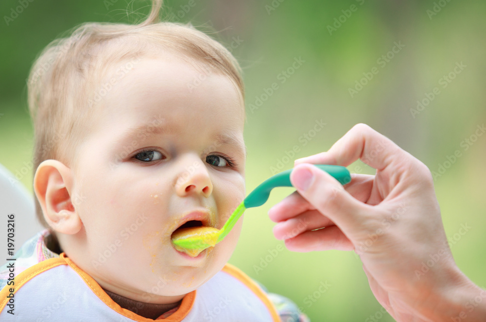 Mother feed her lovely baby
