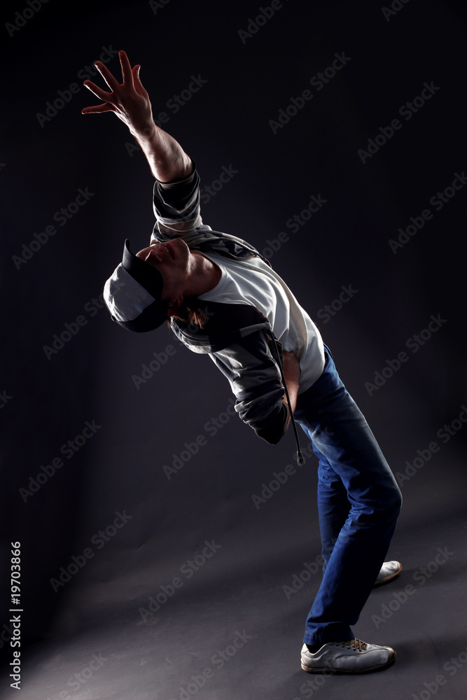 cool man modern dancer against black