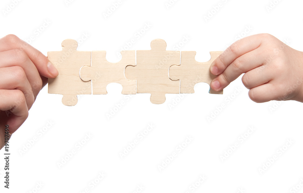 mens and childs hands holding set of puzzles mens and childs hands holding set of puzzles