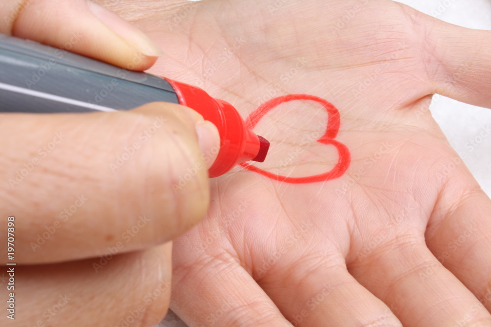 Drawing a heart on the hand