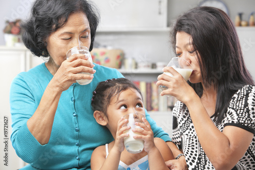 Asian female generations drinking milk