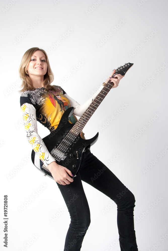 The young beautiful girl with a guitar in hands The young beautiful girl with a guitar in hands