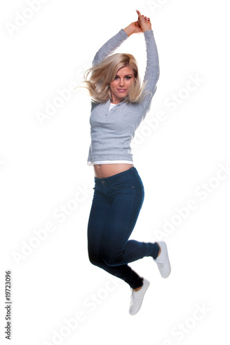Blond woman jumping in the air