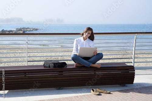 Beautiful woman working with laptop outdoor