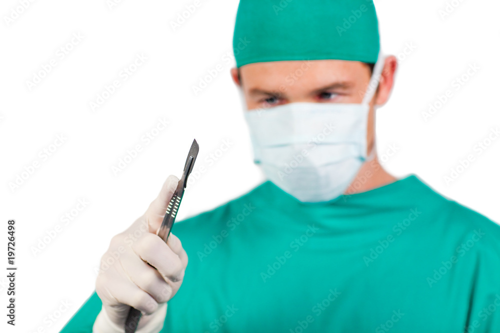 Self-assured surgeon holding a scalpel Self-assured surgeon holding a scalpel