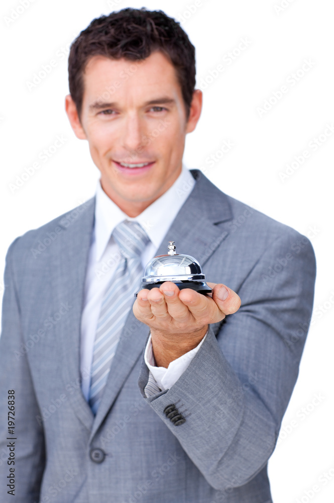 Smiling businessman holding a service bell Smiling businessman holding a service bell