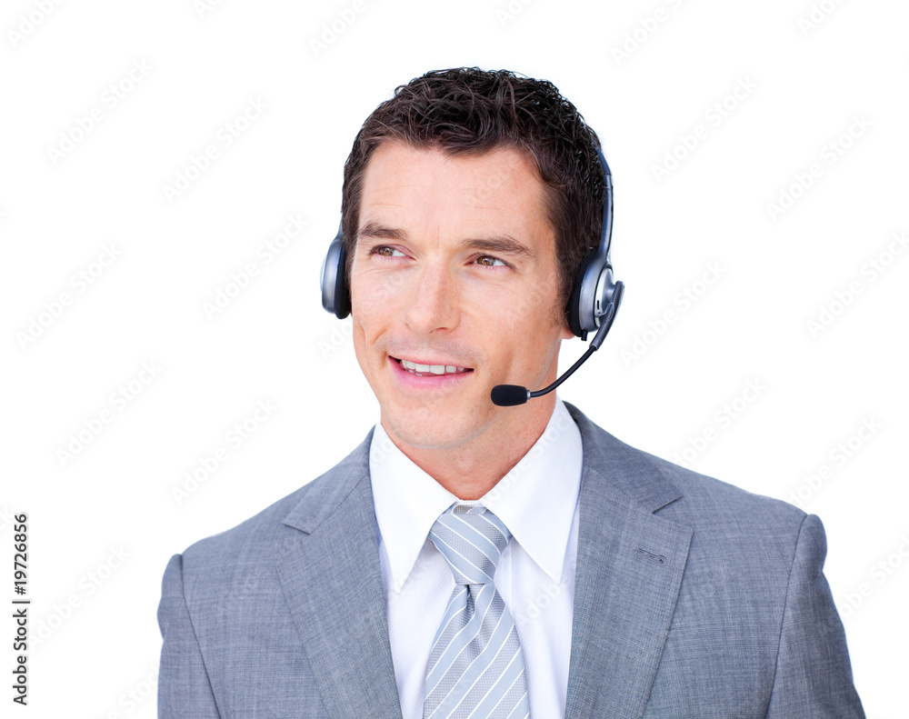 Smiling attractive businessman using headset Smiling attractive businessman using headset