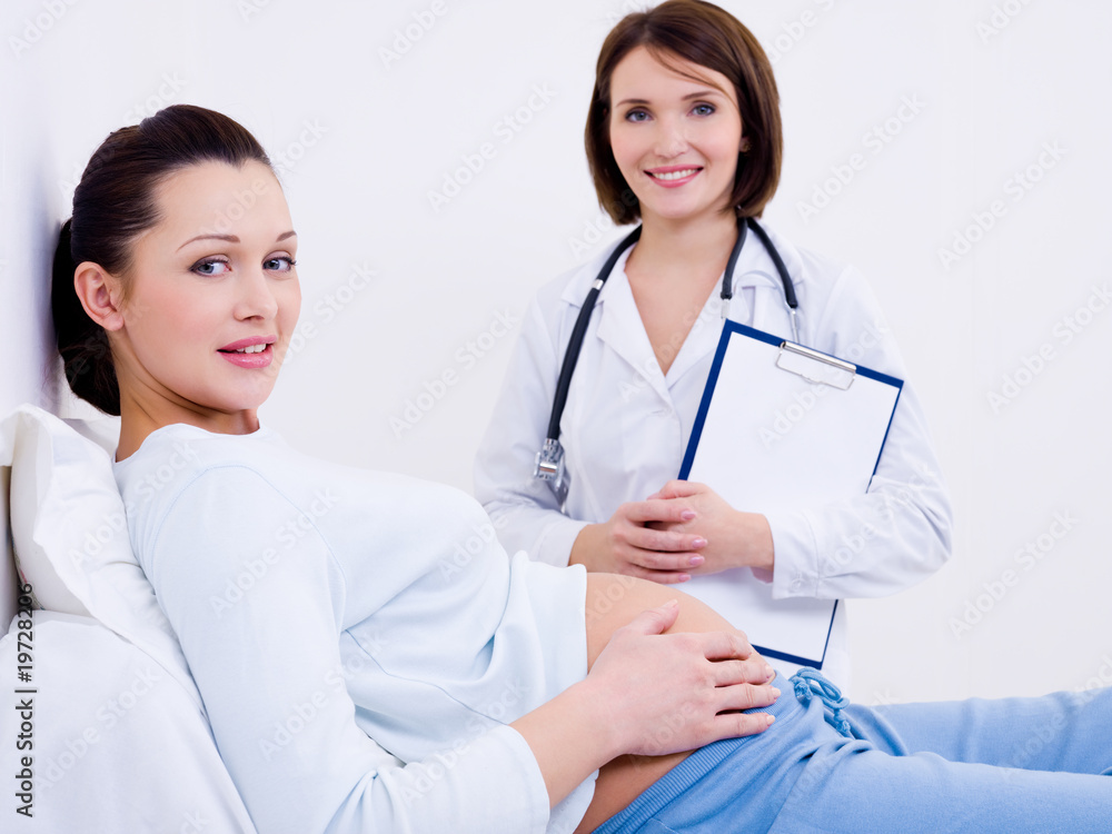Beautiful pregnant woman with the doctor Beautiful pregnant woman with the doctor