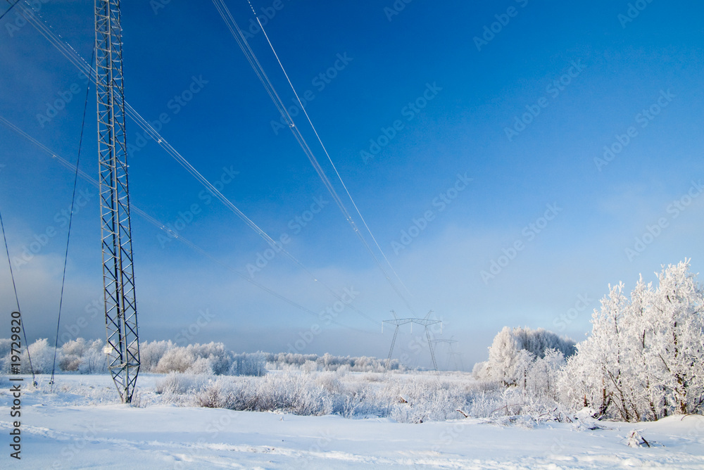 Obraz premium Winter high-voltage transmission tower