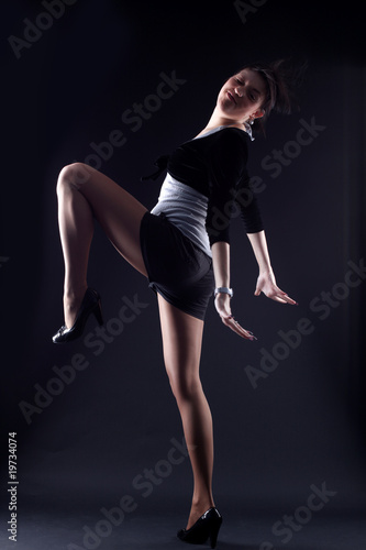 cool woman modern dancer against black