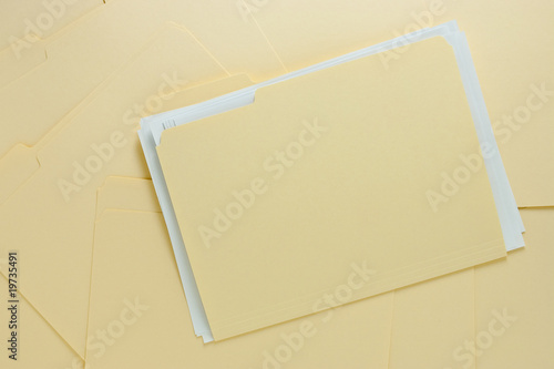 File Folder with Paper on Messy Pile