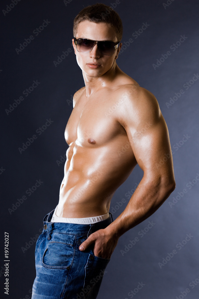 young bodybuilder man on black background young bodybuilder man on black background