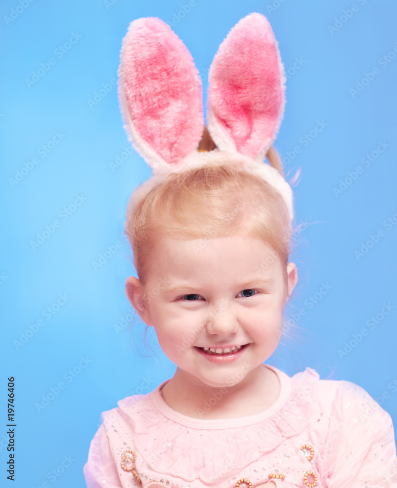 little girl wearing Easter bunny ears on head little girl wearing Easter bunny ears on head