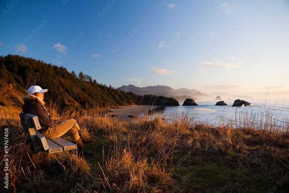 woman on bench overlooking coast woman on bench overlooking coast