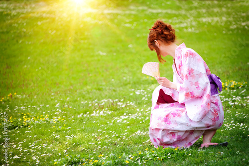 beautiful young woman in a Kimono in the Gardens