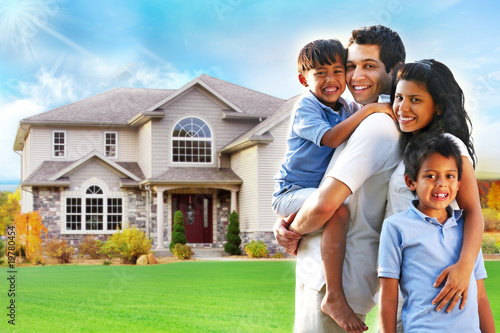 Happy family portrait in front of house