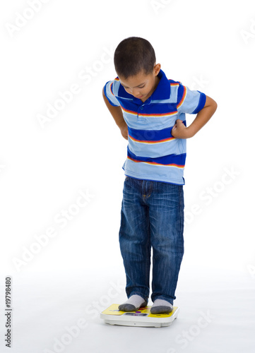 young boy on scale