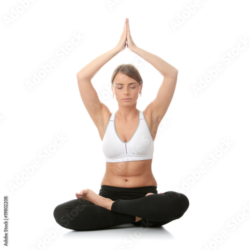 Fototapeta Naklejka Na Ścianę i Meble -  Beautiful young woman doing yoga exercise