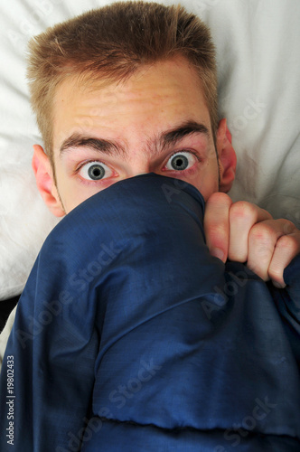 Quadro em tela Young adult teen hides under covers