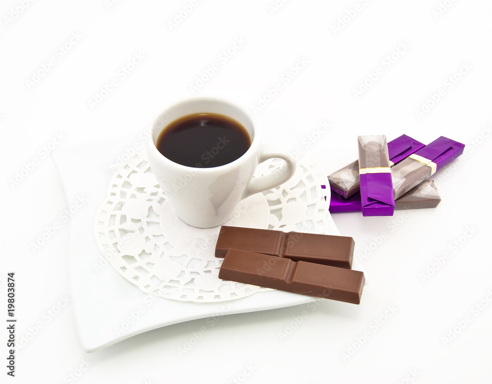White coffee cup and some bars of chocolate