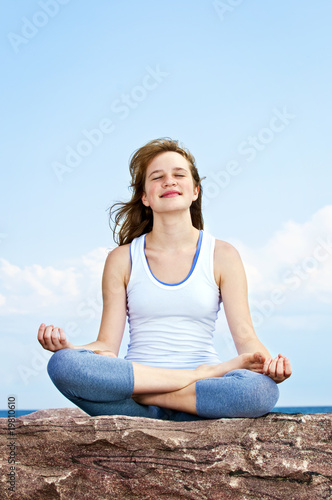 Young girl meditating outdoors