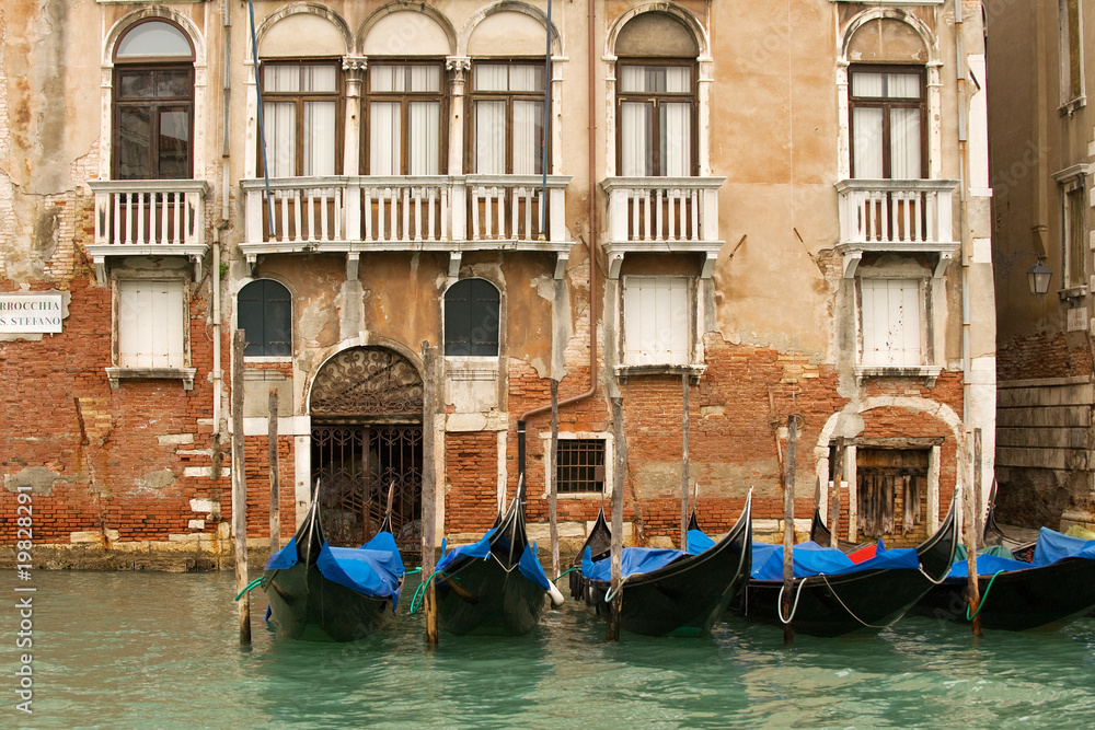 Row of gondolas along Grand Canal houses, Venice
