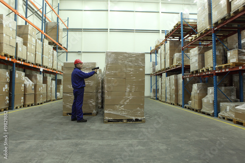 worker with bar code reader working in warehouse