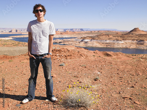 Young Man in Standing with Hands in Pockets