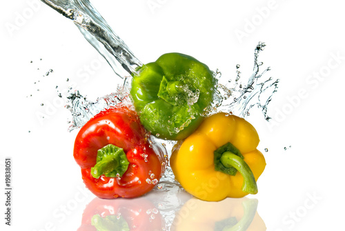 red  yellow  green pepper  with water splash isolated on white