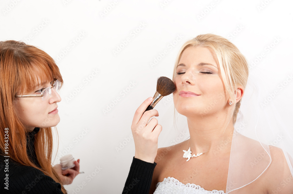 Young happy bride making wedding make-up