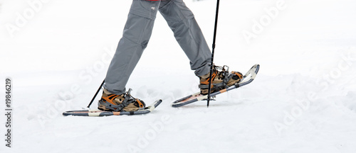 Senior at the snow-shoe walking in winter photo