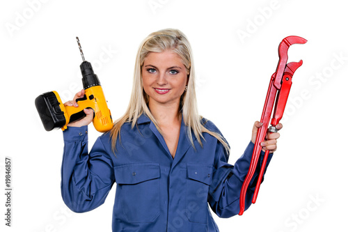 Woman in blue work clothes with drill photo