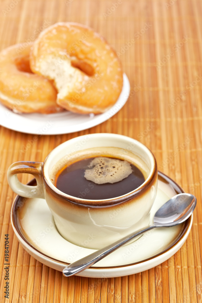 Delicious coffee and two donuts Delicious coffee and two donuts