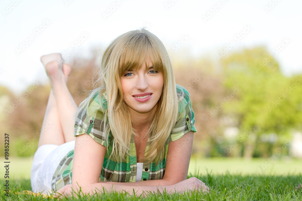 POrtrait of beautiful woman laying on grass POrtrait of beautiful woman laying on grass