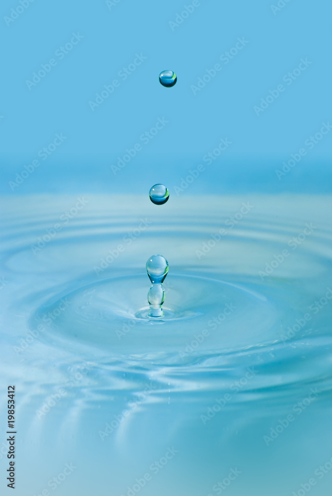 Clean blue drop of water splashing in clear water. Abstract blue Clean blue drop of water splashing in clear water. Abstract blue