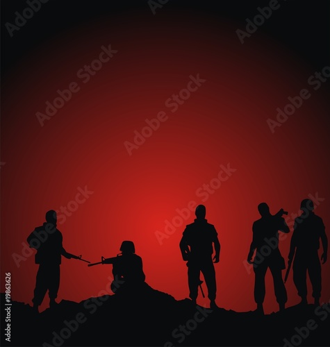 soldiers silhouettes standing against sunset background