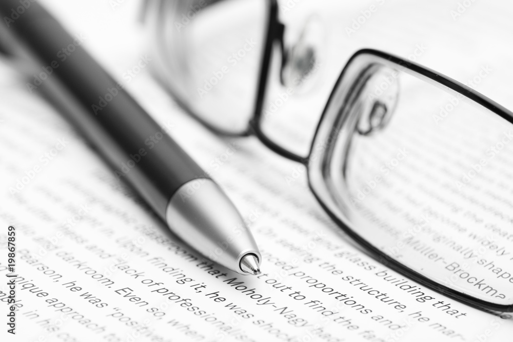 Open book with glasses and pen Open book with glasses and pen