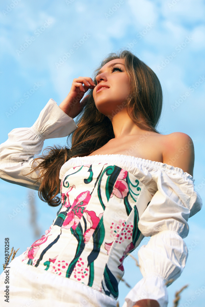 The young woman in a white dress in the field of wheat. The young woman in a white dress in the field of wheat.