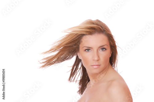 A beautiful young woman with her hair blowing