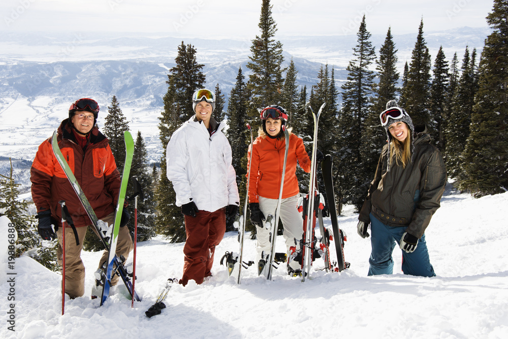 Obraz premium Skiers Standing in Snow Smiling