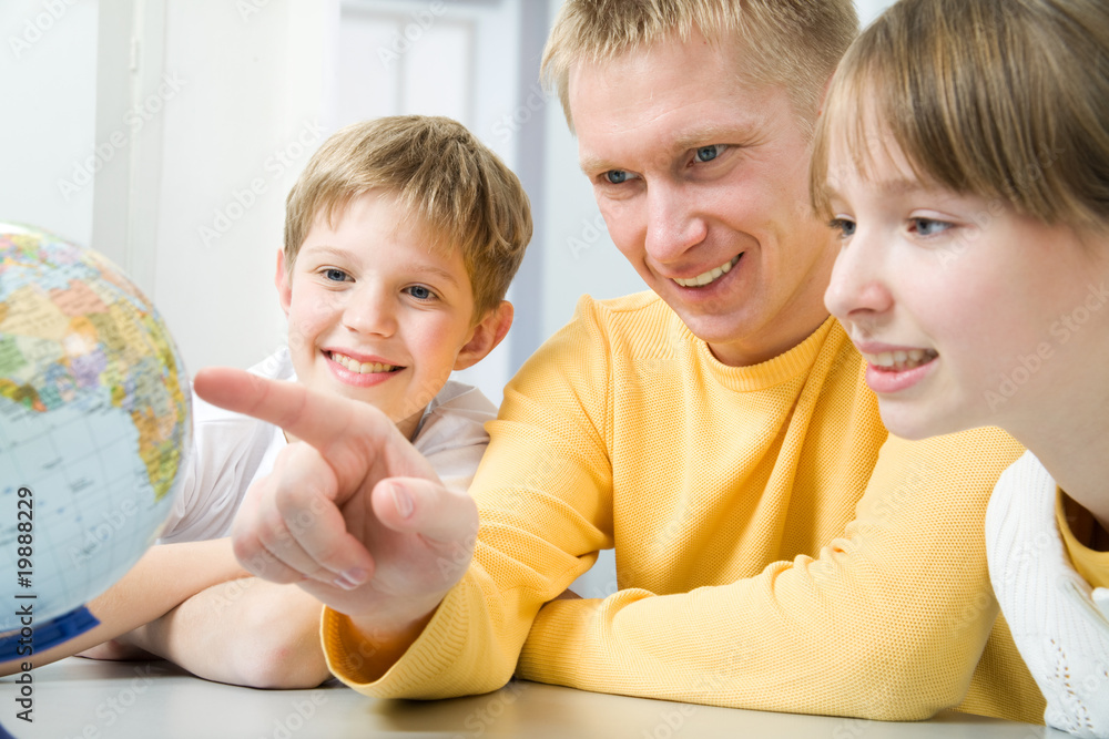 Happy family examining a globe Happy family examining a globe