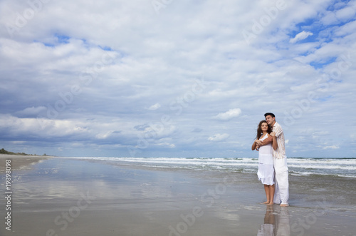 Man and Woman Couple Having In Romantic Embrace On Beach