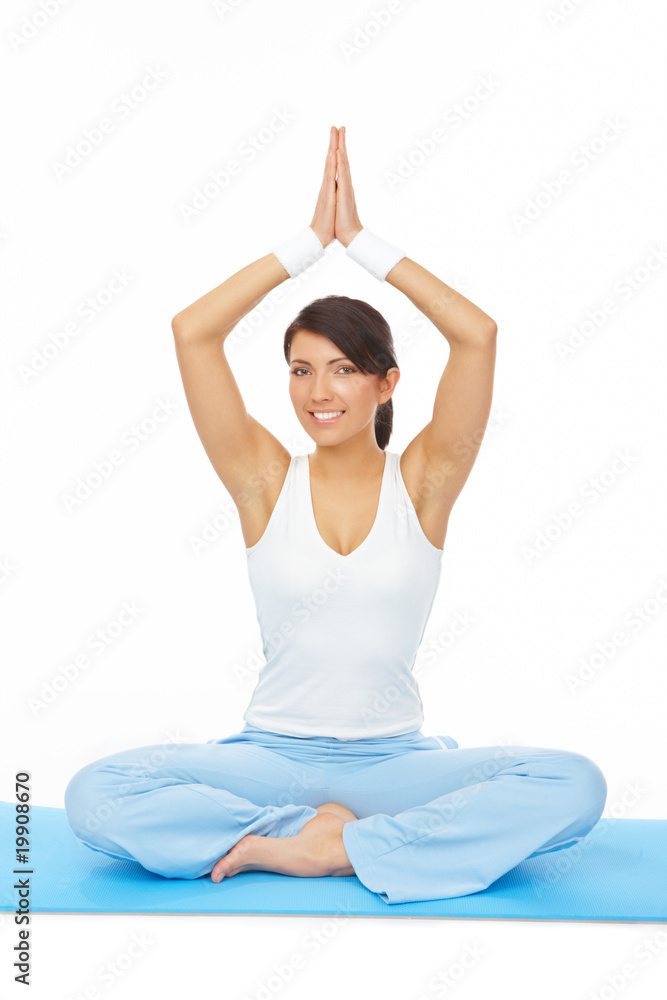 Young woman doing yoga exercise on mat Young woman doing yoga exercise on mat