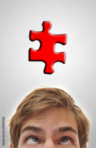 Man looking up at puzzle piece photo