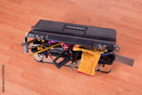 tools in tool box on wooden floor