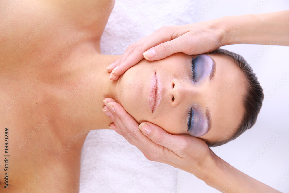 Beautiful young woman receiving facial massage. Beautiful young woman receiving facial massage.