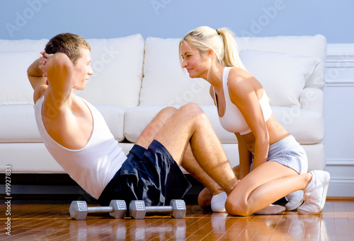 Couple Exercising on Living Room Floor