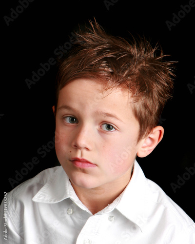 Little boy with a forlorn or skeptical expression