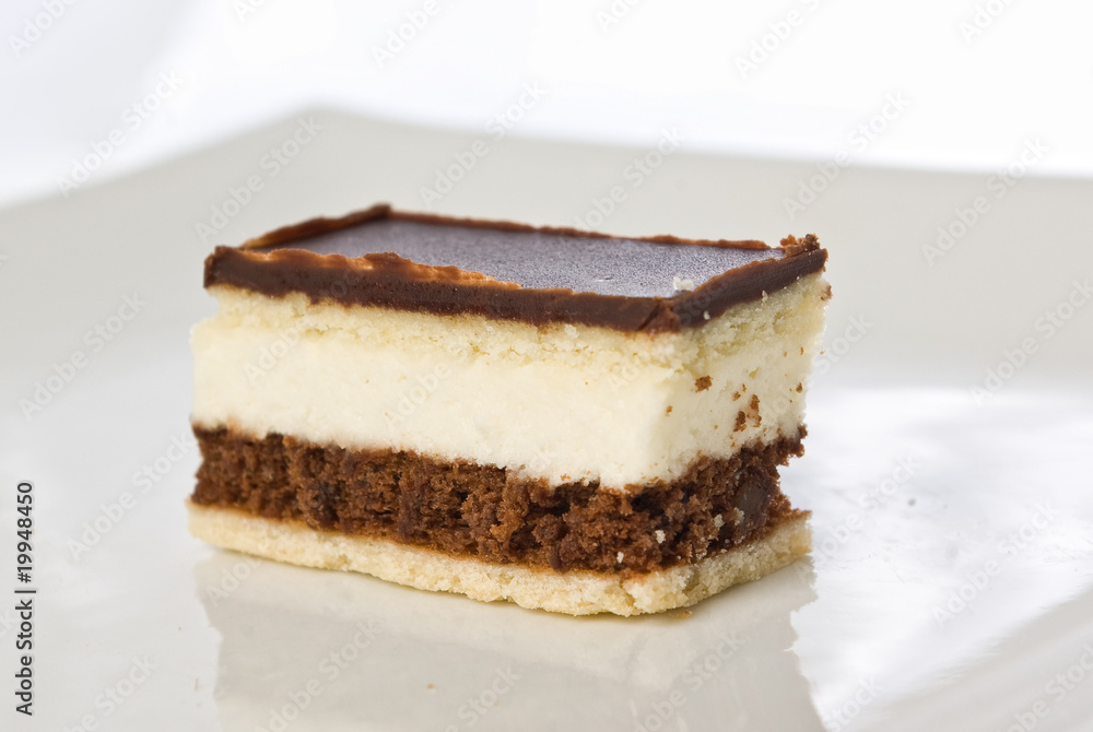 piece of a chocolate cake with white cream on a plate piece of a chocolate cake with white cream on a plate